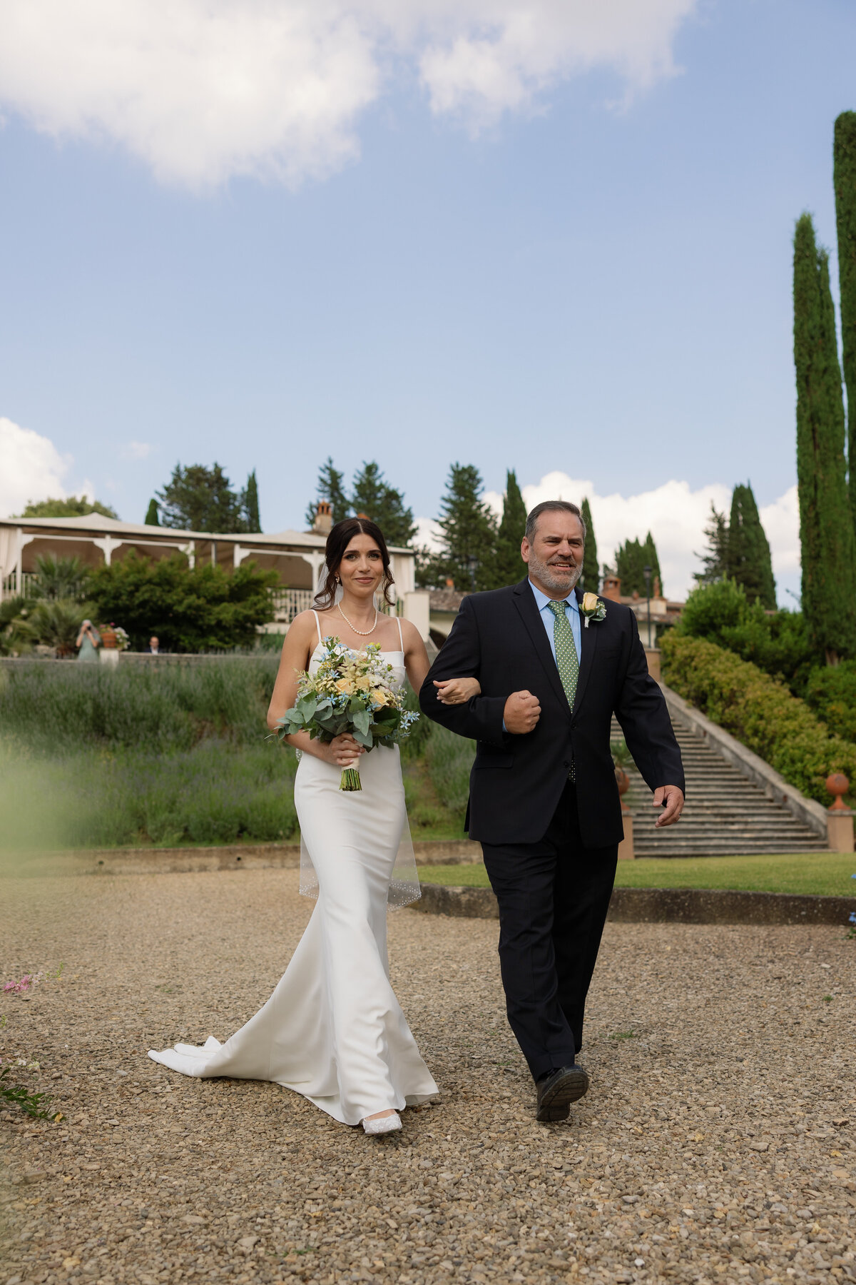 dad walks his daughter down the aisle at a Tuscany Ceremony