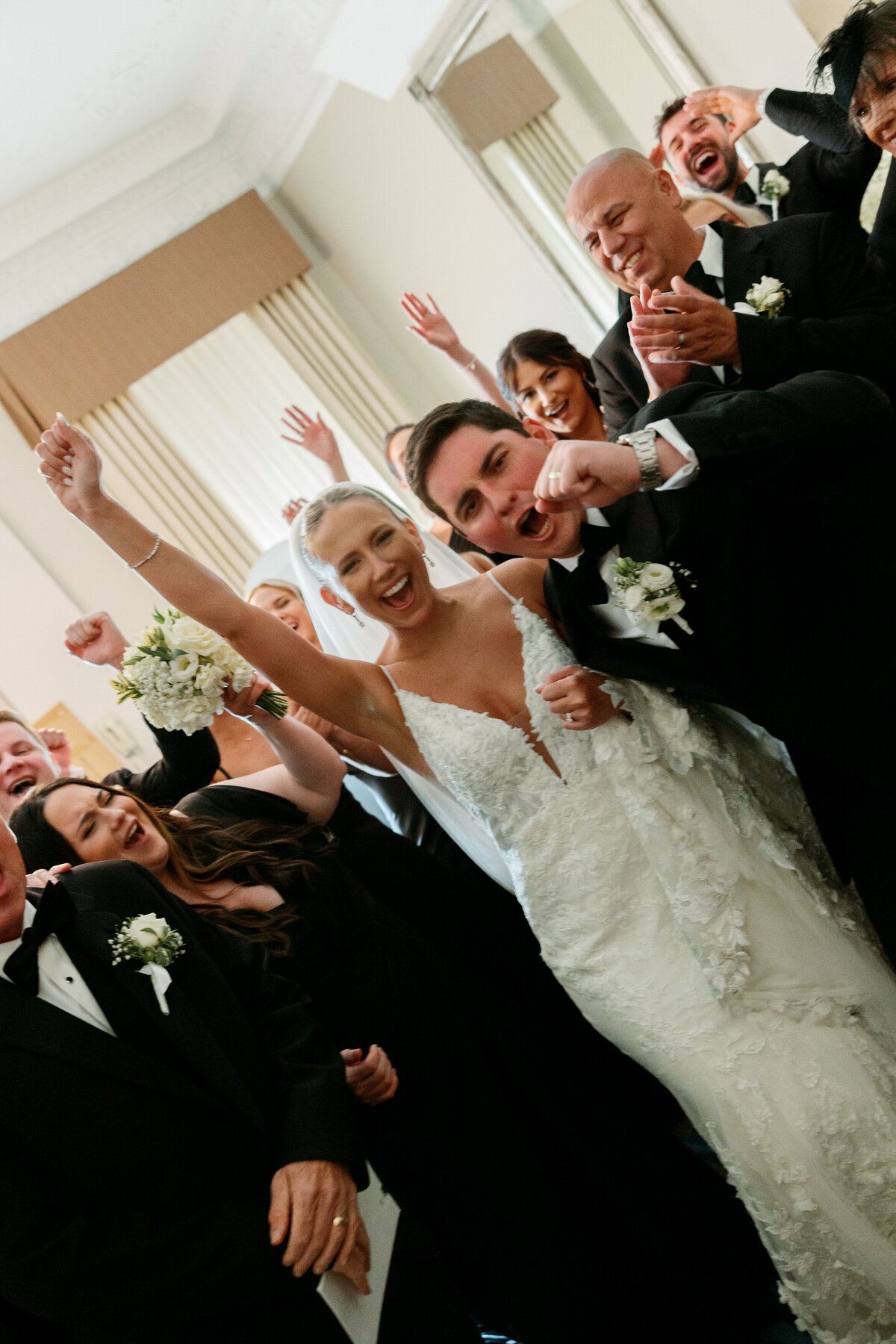 Bride and groom celebrate with guests after ceremony by Philadelphia wedding photographer.