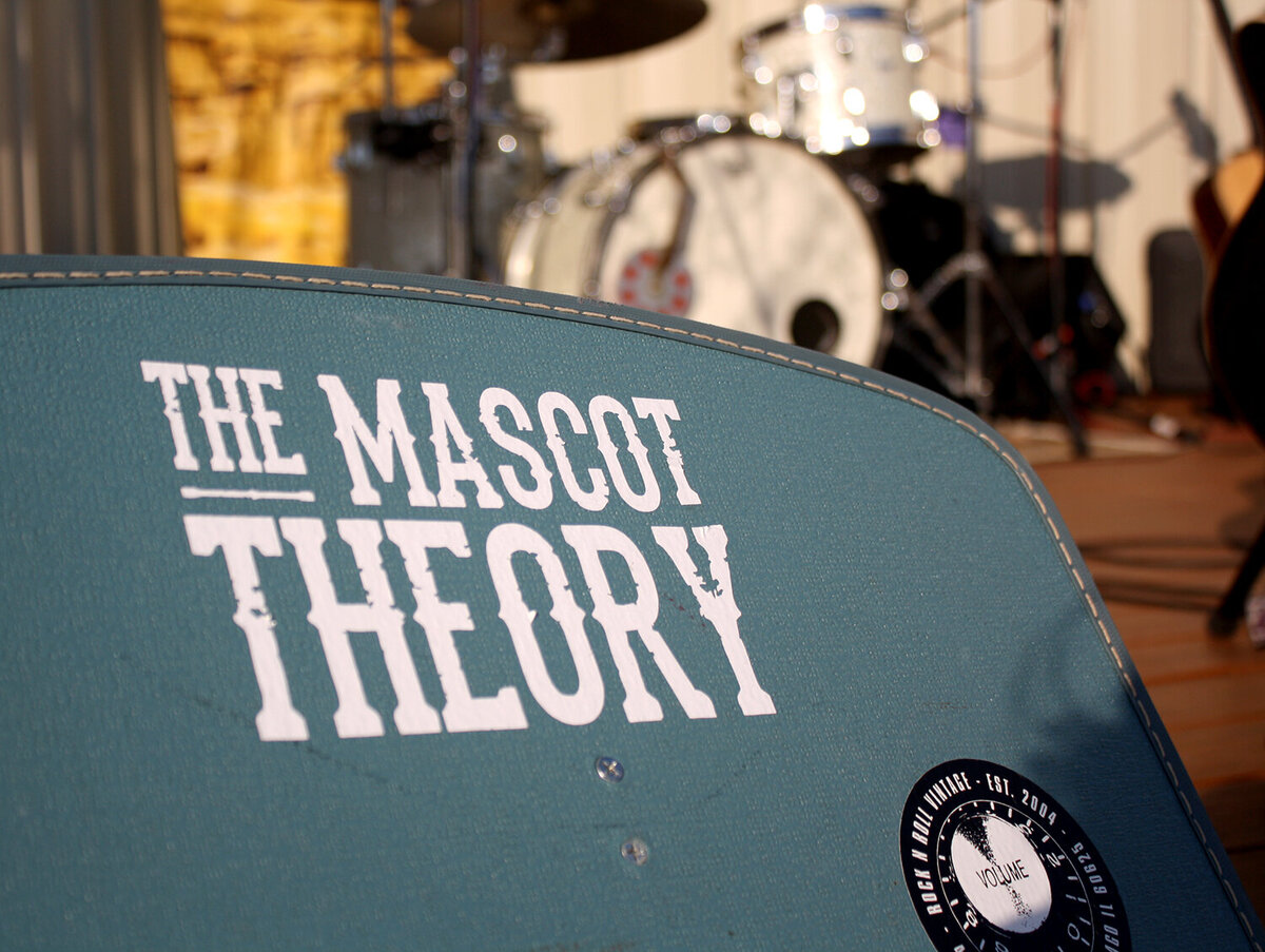 The Mascot Theory logo in front of stage