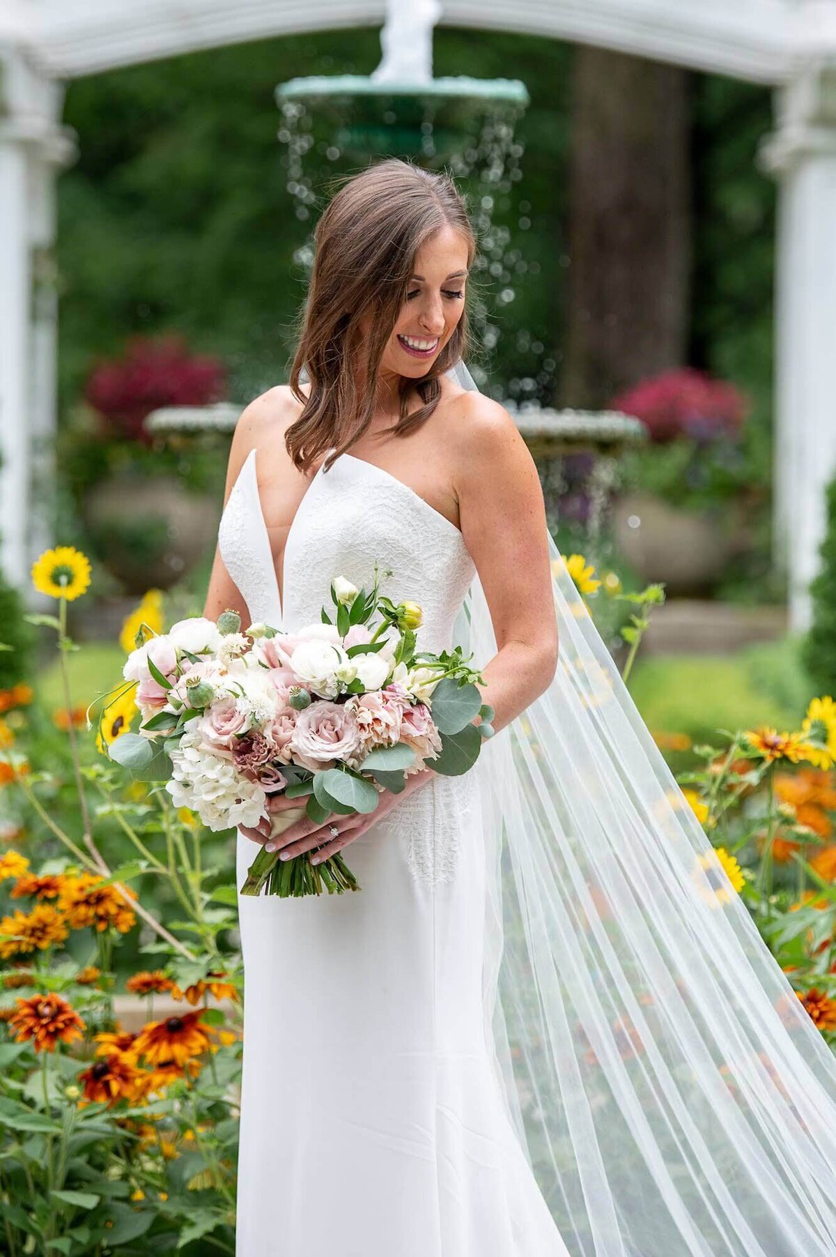 Anna Barnard Wedding - bride smiling with flowers