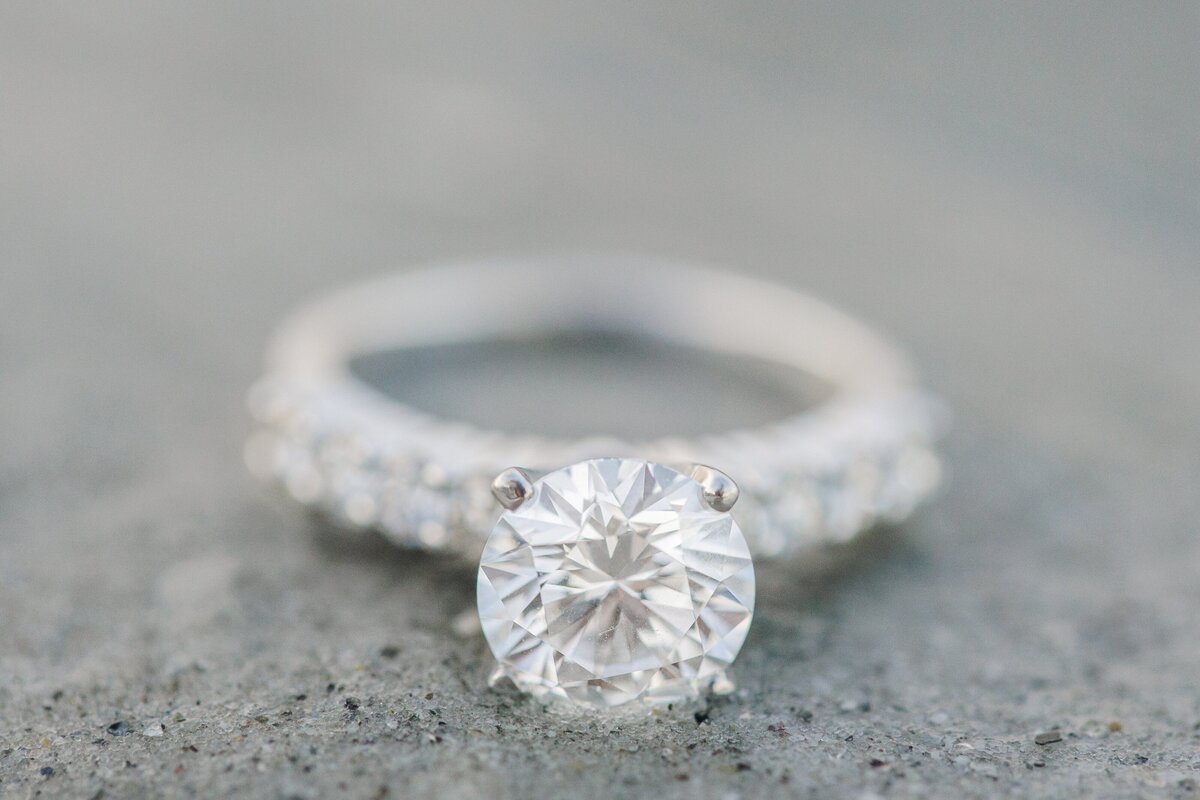 A solitaire engagement ring on the sand at Wingaersheek Beach