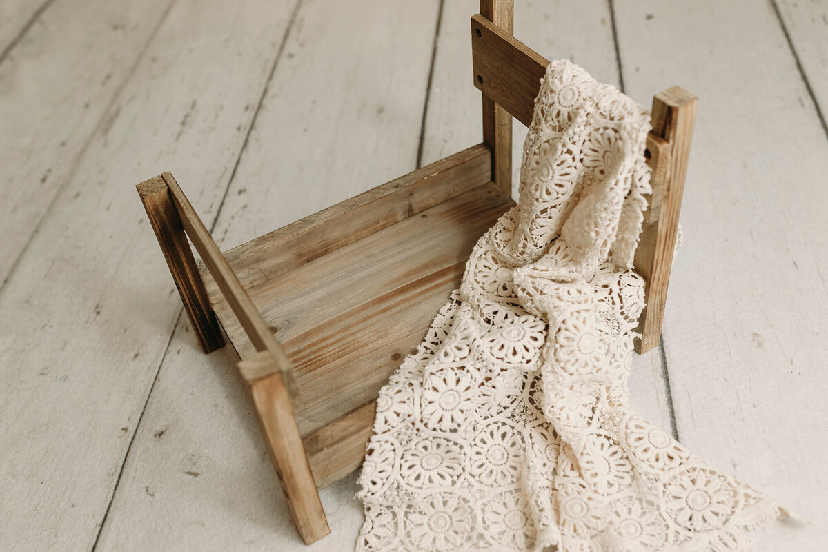 Wooden bed prop used in newborn sessions.
