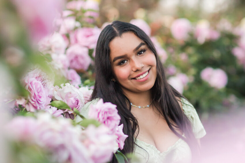 Senior girl sitting in purple roses