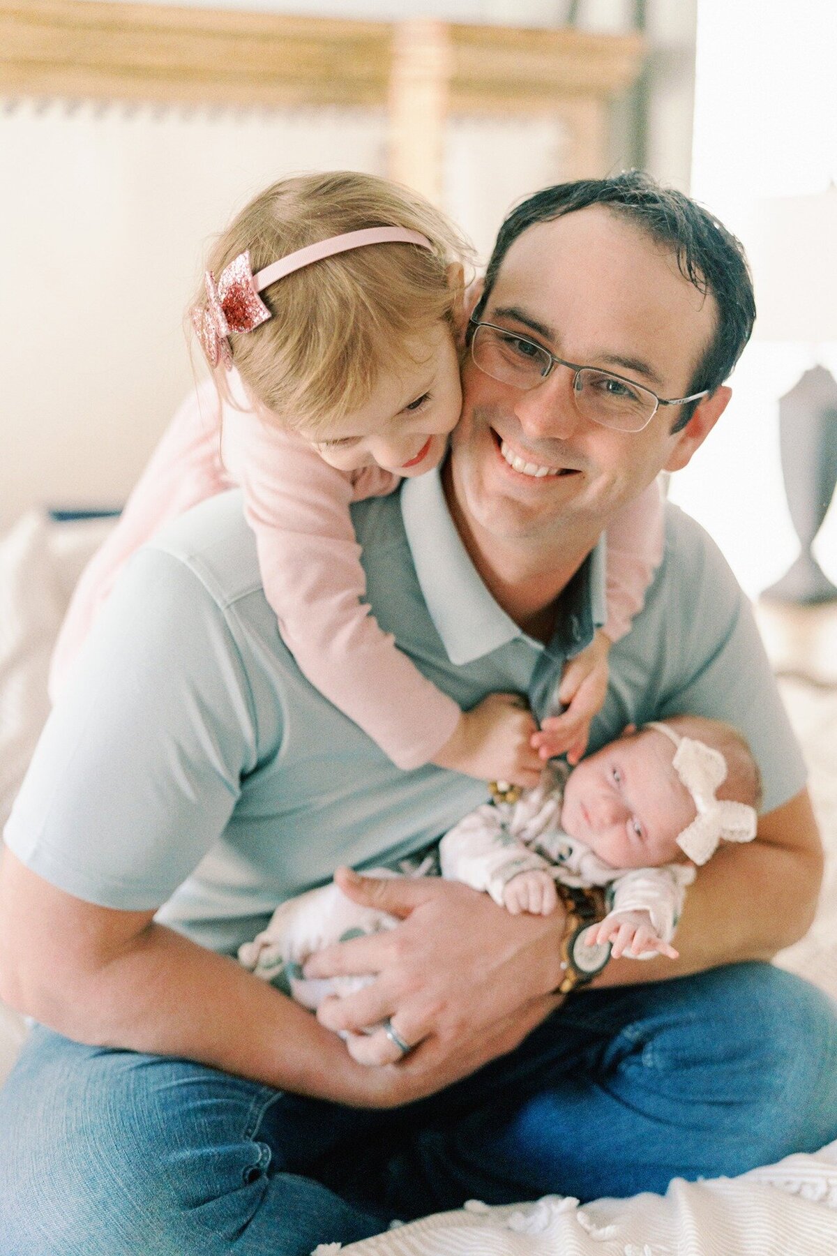 dad-holding-both-his-baby-girls