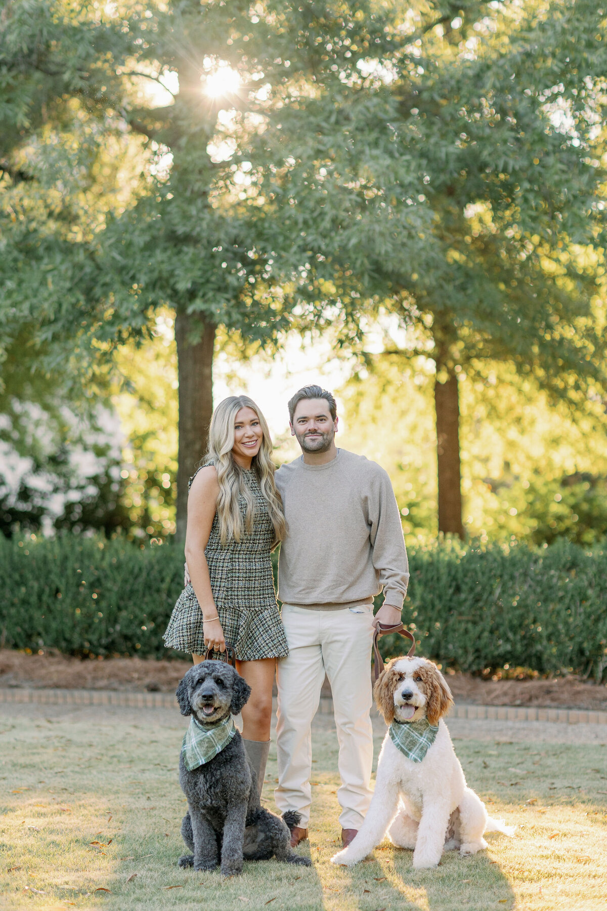 Couple smiling with their dogs in a park