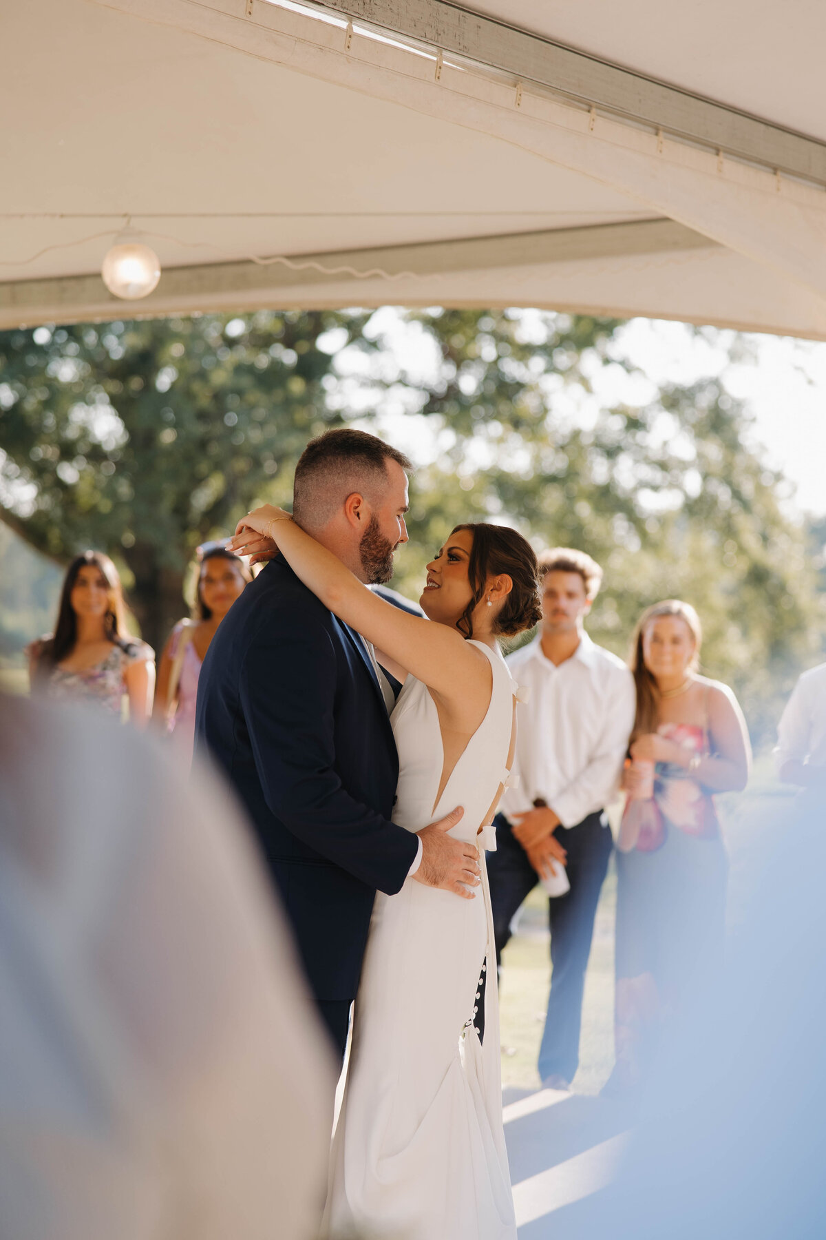 bride and groom first dance surrounded by loved ones