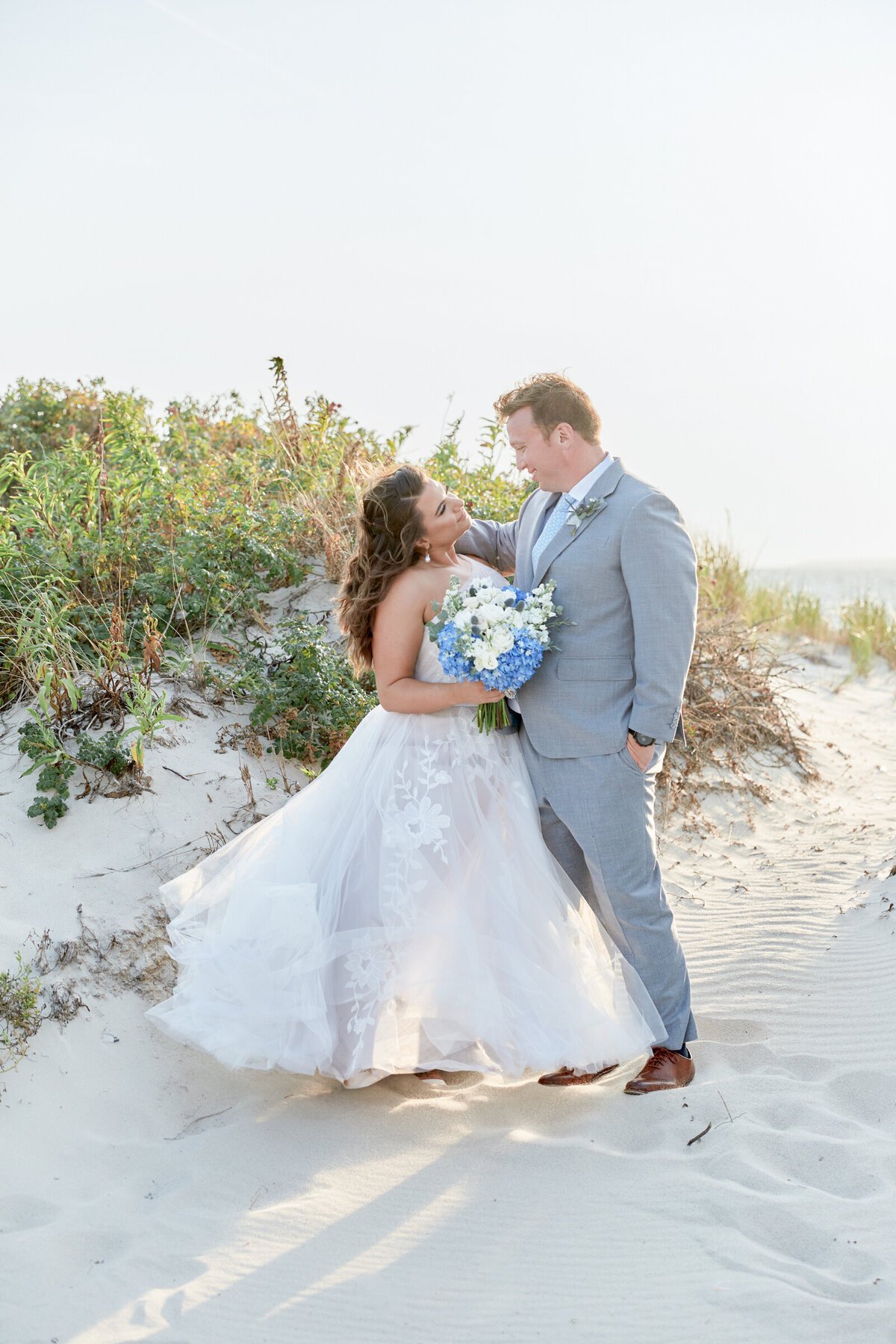 A bride and groom on the dunes of Cape Cod