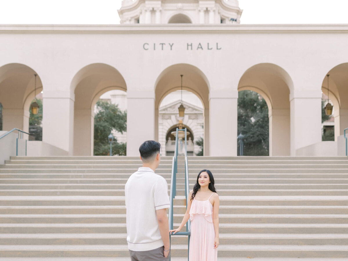 couple facing each other on steps of pasadena city hall