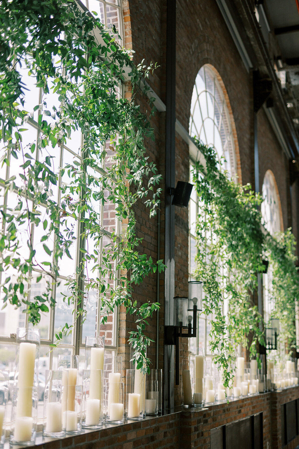 greenery in front of windows with candles