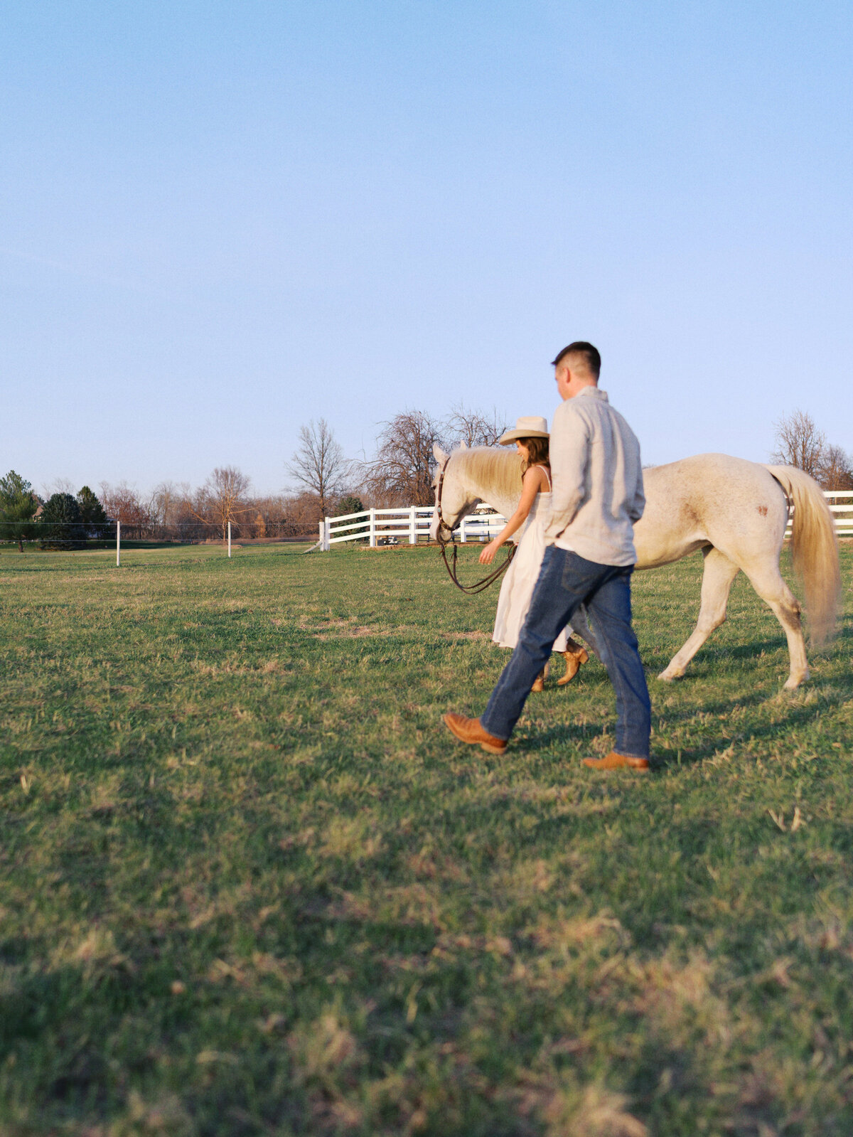 engaged-couple-walking-with-horse