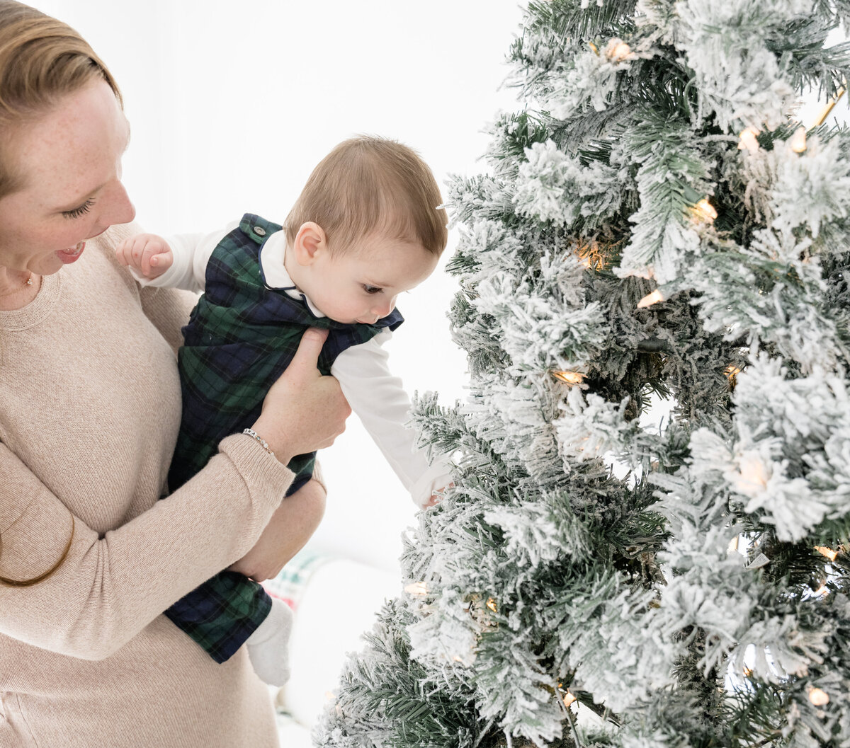 Baby exploring Christmas tree in studio photos