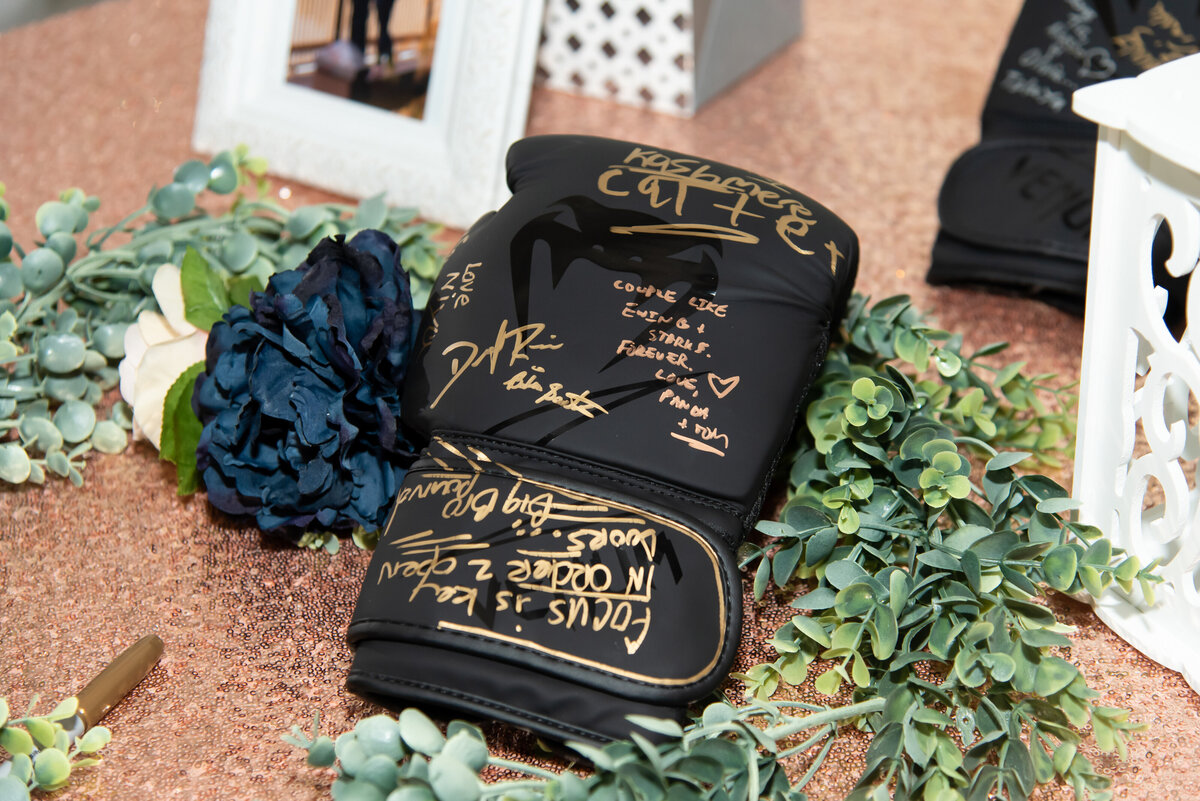 black boxing glove with gold writing guest book