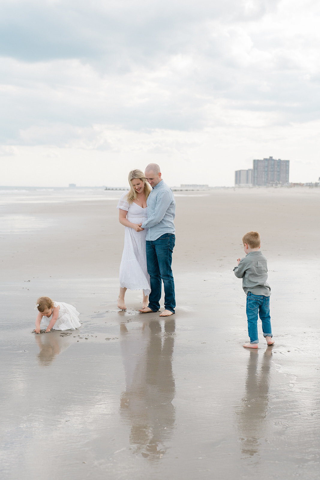 A mom, dad and their kids playing on the beach in New Jersey