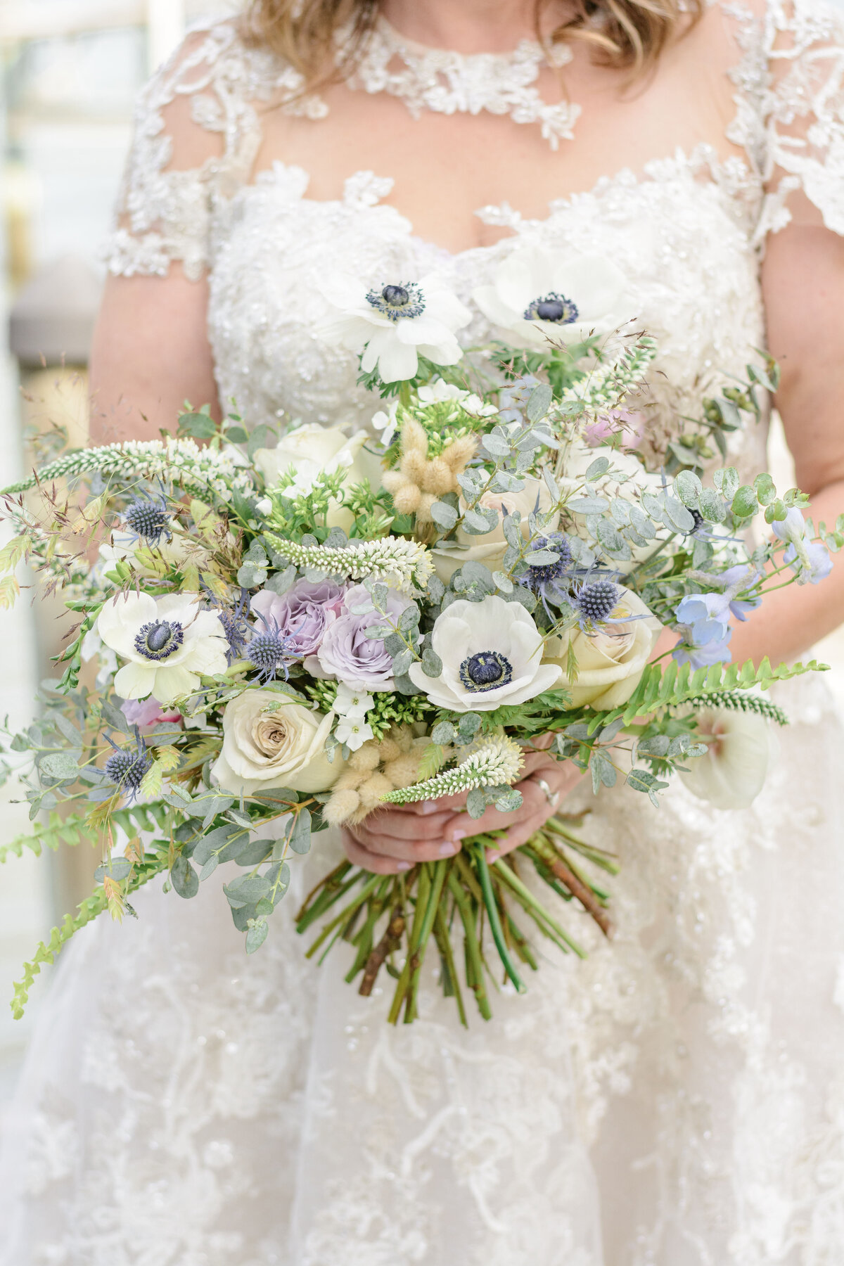 Ashley Hall Photography Bride holding an oyster ispired bouquet