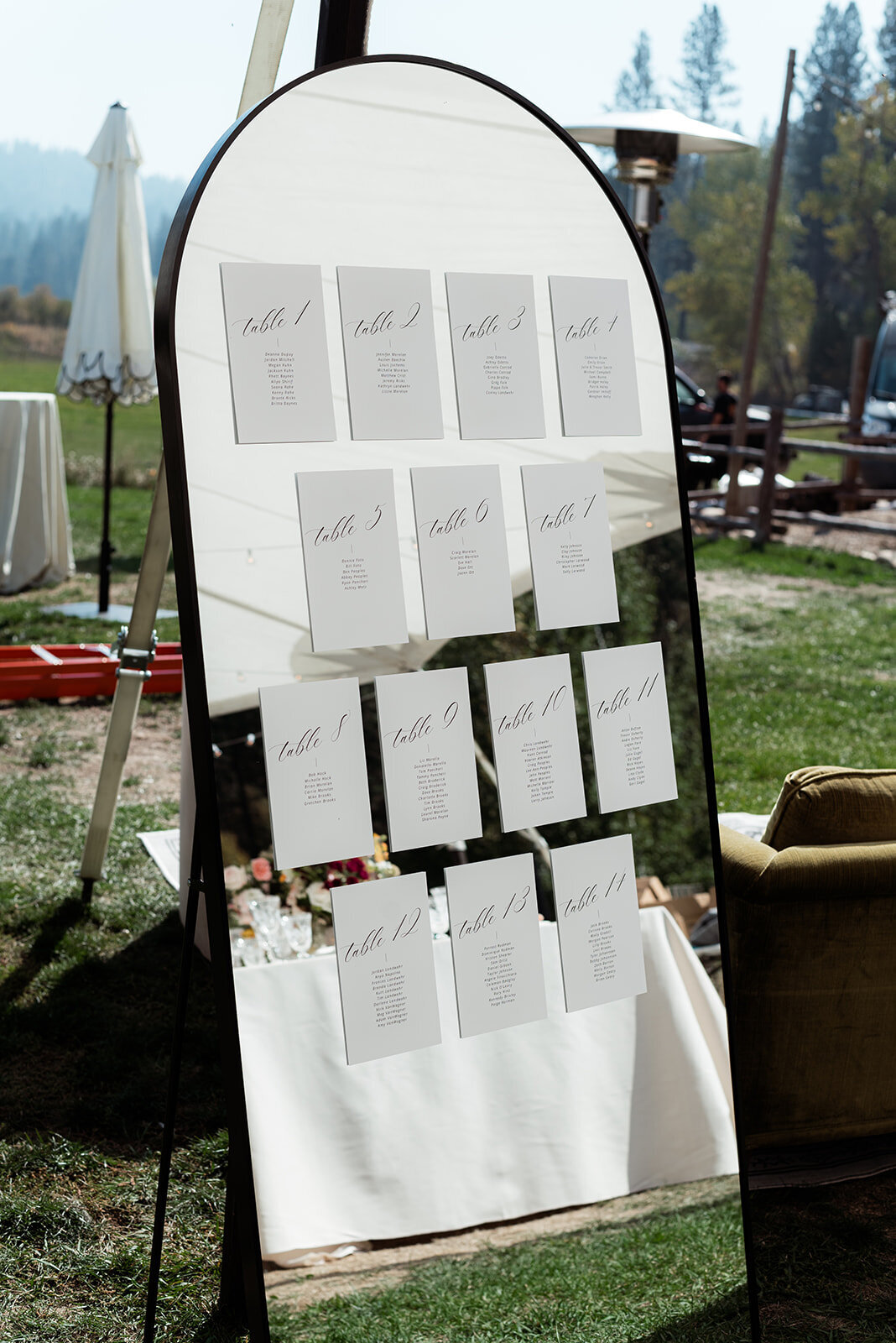 Table seating charts hanging on a mirror.