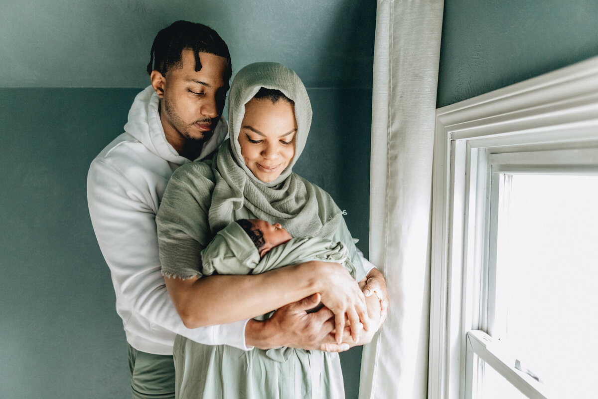 Family Photoshoot Session with dad and mom holding newborn baby.