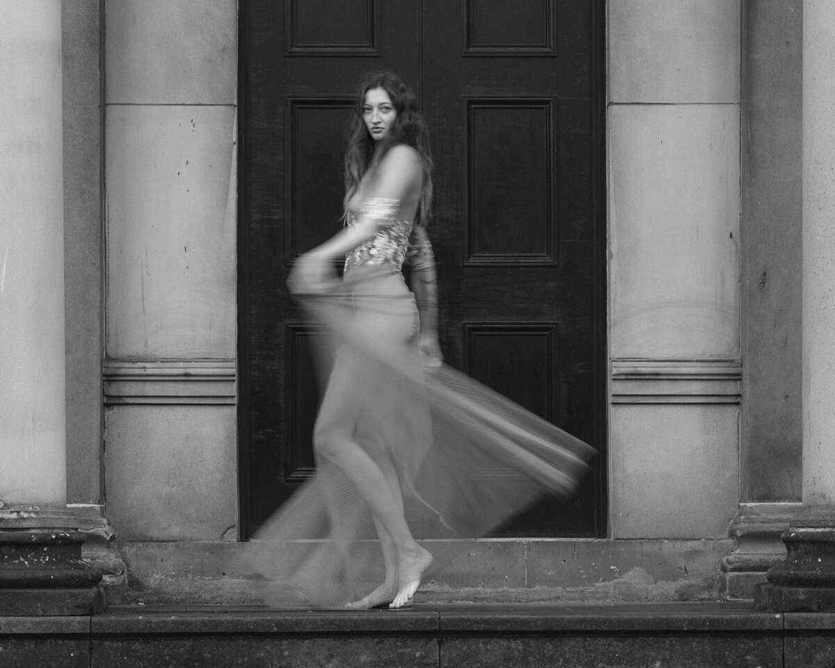 A bride spins, bare foot in a sheer wedding dress
