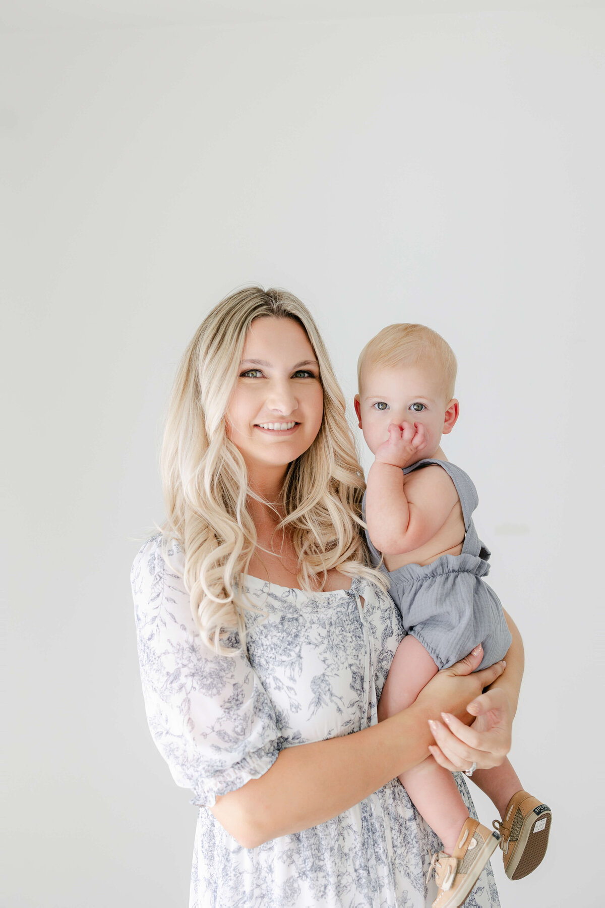 a mom holding her one year old