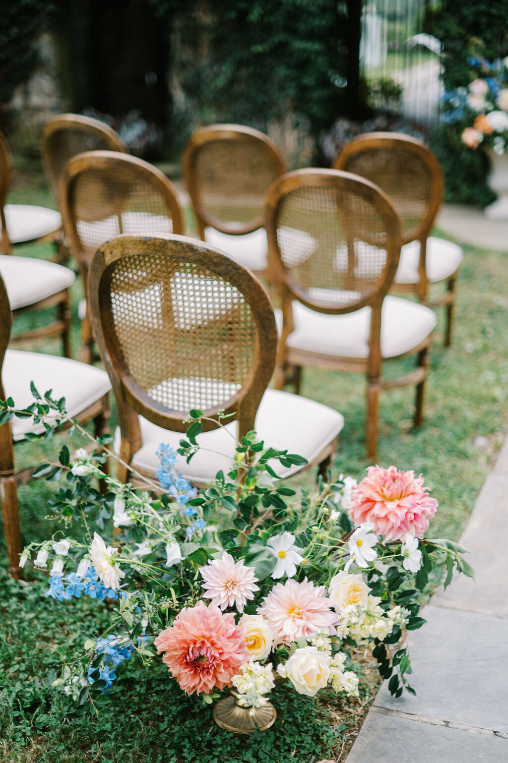 Colorful wedding florals and wedding ceremony chairs