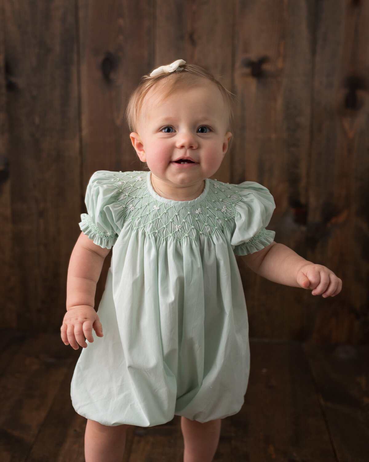 standing baby portrait in green dress by Laura King, Houston Photographer