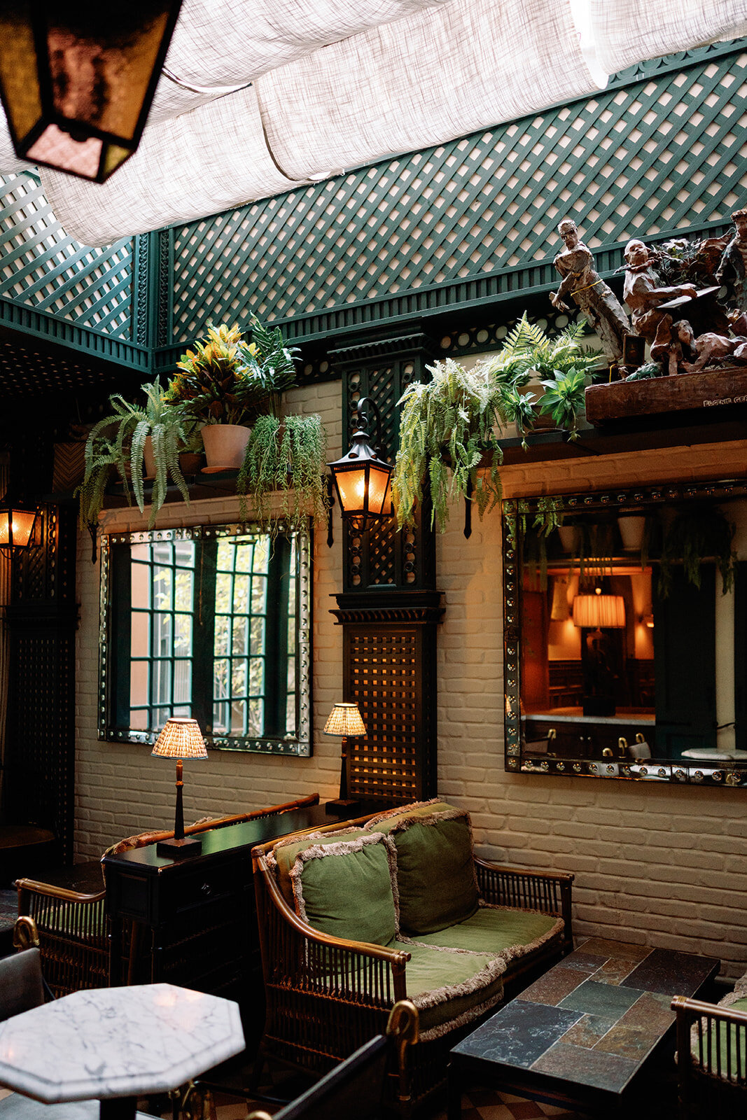 Elegant interior of Hotel Chelsea in New York City with vintage decor and greenery, captured during Japna and Chris’s intimate elopement by NYC wedding photographer Perry Hancock.