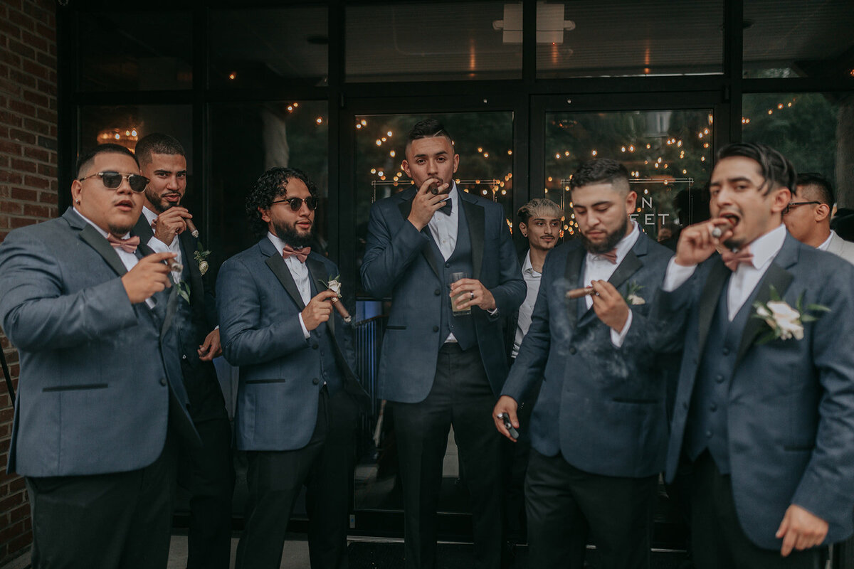 Groom and groomsmen holding tabacco