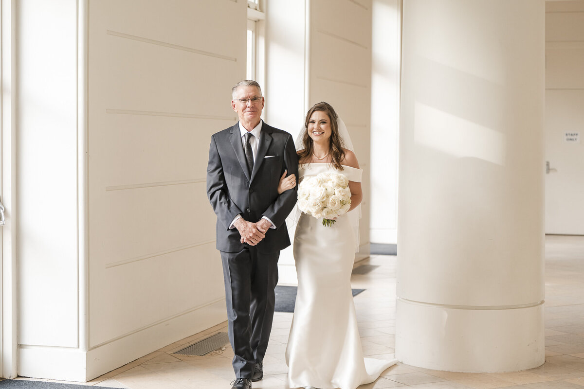 Father of the bride walking his daughter down the aisle Wedding at the Fernbank Musum in Atlanta photographed by Ocala wedding photographers