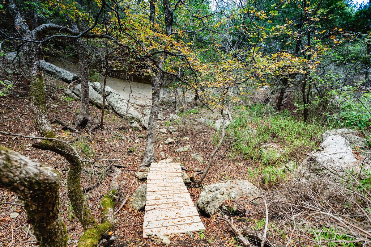 Hiking trail with small bridge at this three-bedroom, two-bathroom ranch house for 7 with incredible hiking, wildlife and views.