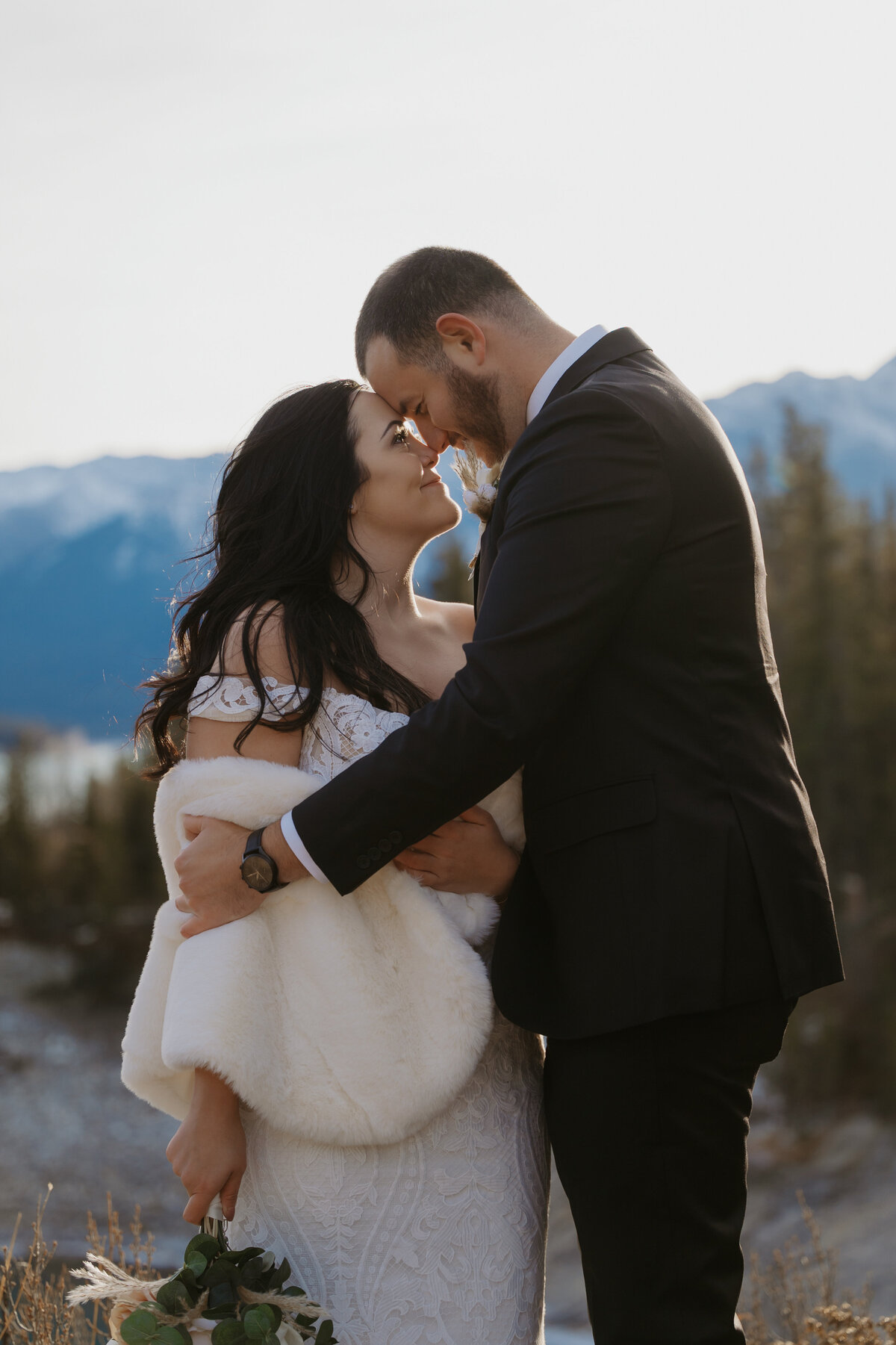 Bride and groom couples outdoor photo looking into each others eyes