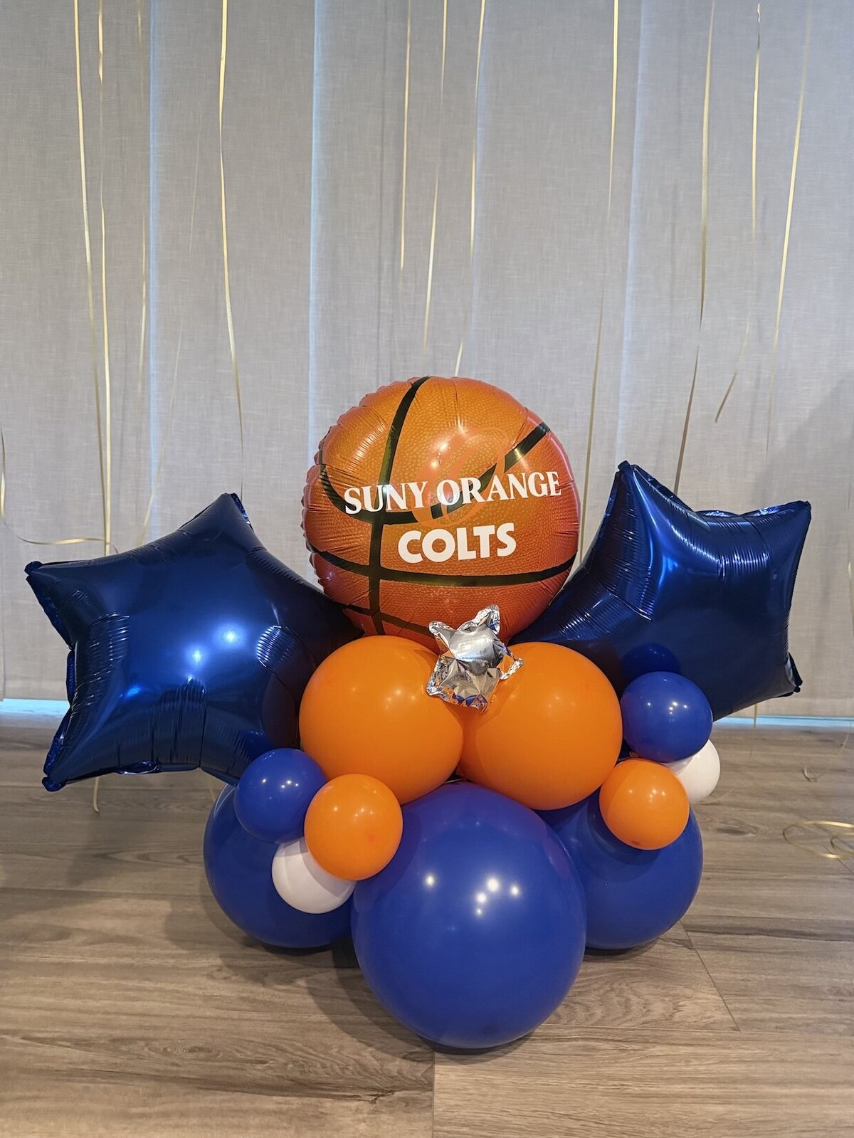 Balloon centerpiece for a graduation party in fort myers, florida with blue and orange balloons