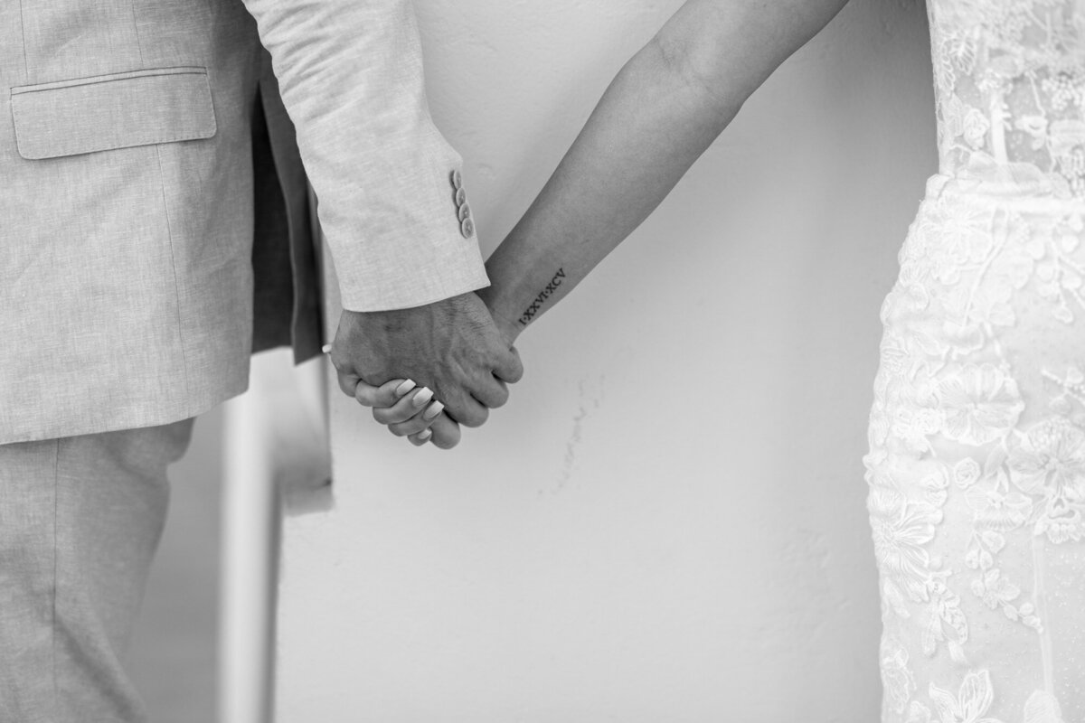 Bride and groom holding hands at Hilton Beachfront Resort Santa Barbara