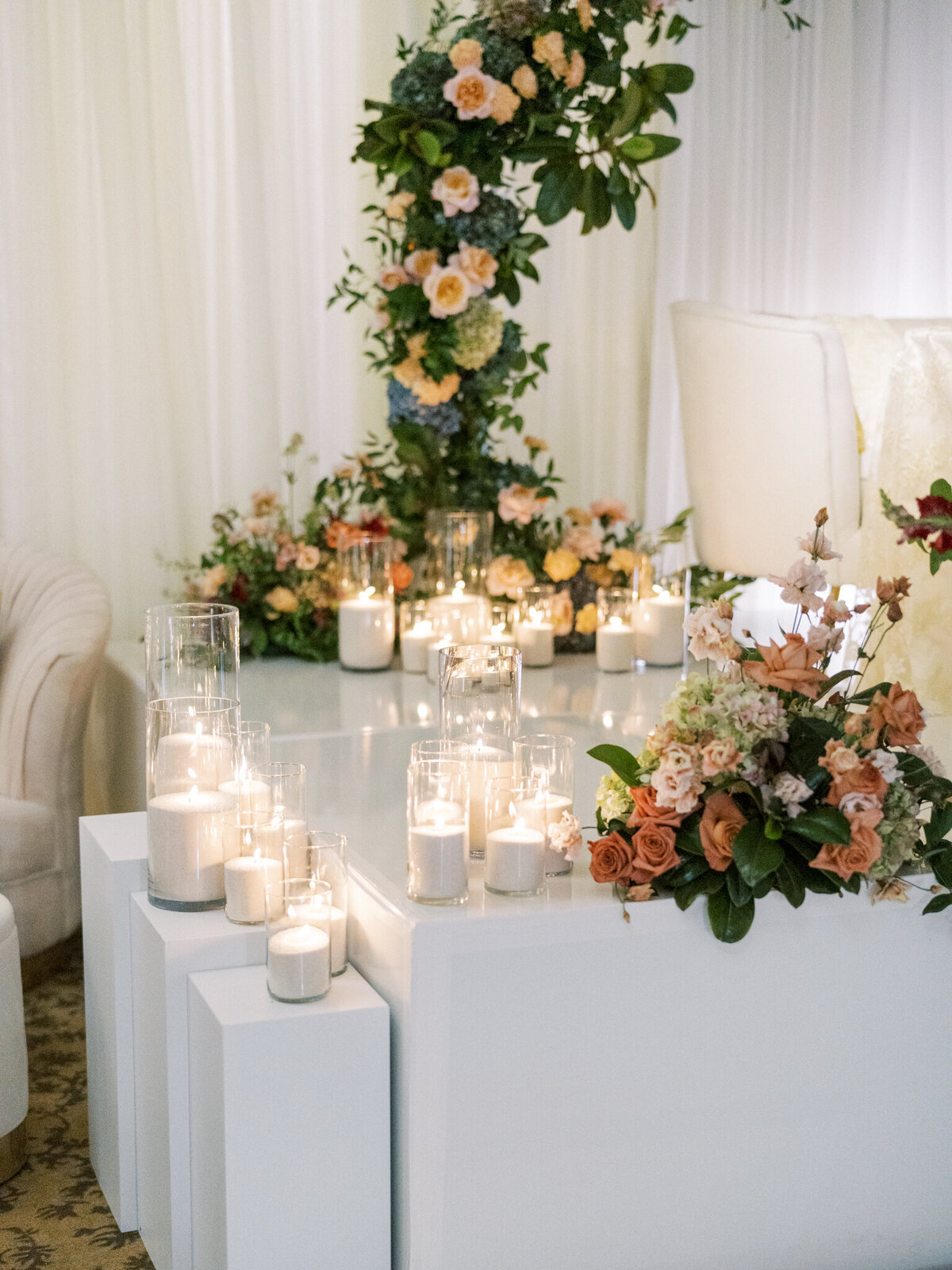Romantic sweetheart table glowing with candlelight and lush florals—elevated vineyard elegance at its finest.