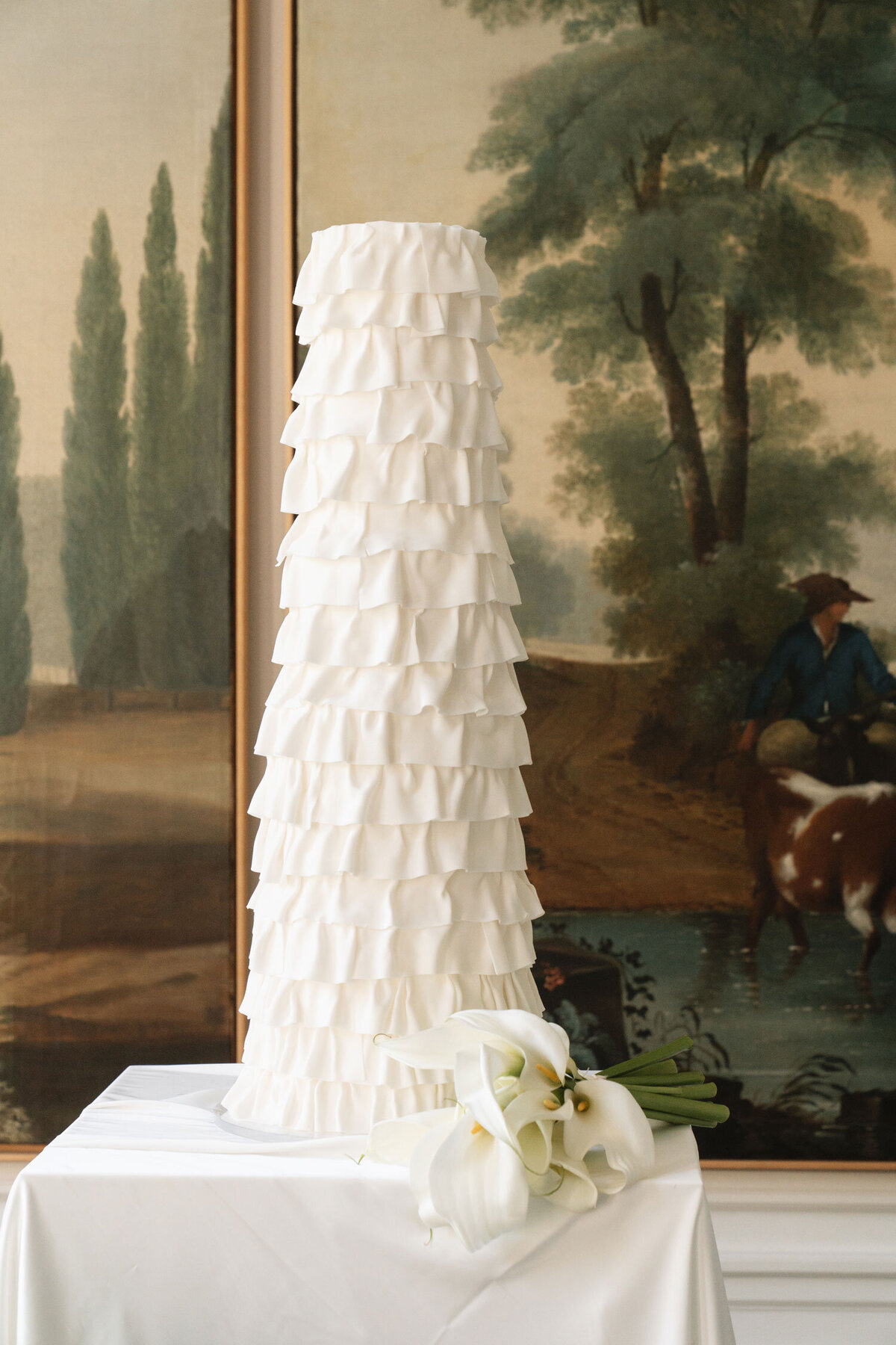 Tall modern wedding cake with ruffles and textures, designed for an Amsterdam canal-side wedding