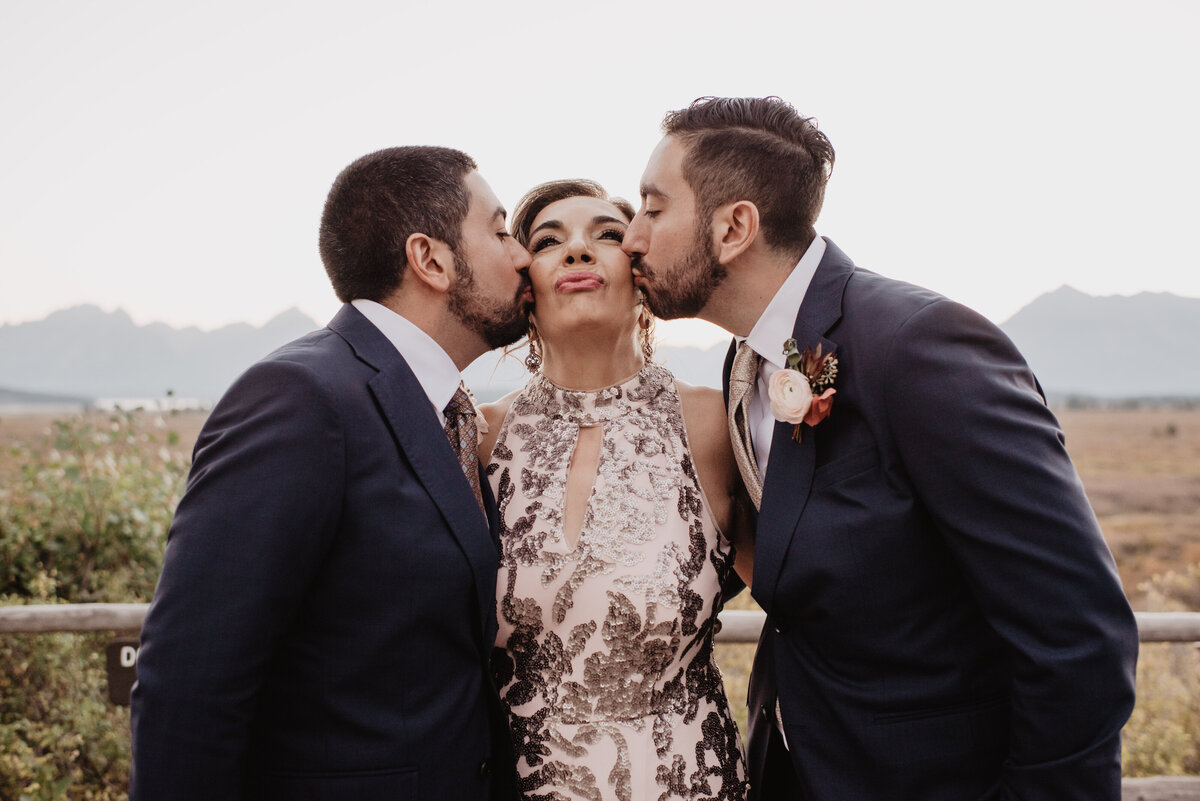 Photographers Jackson Hole capture groom and brother kissing mother's cheek
