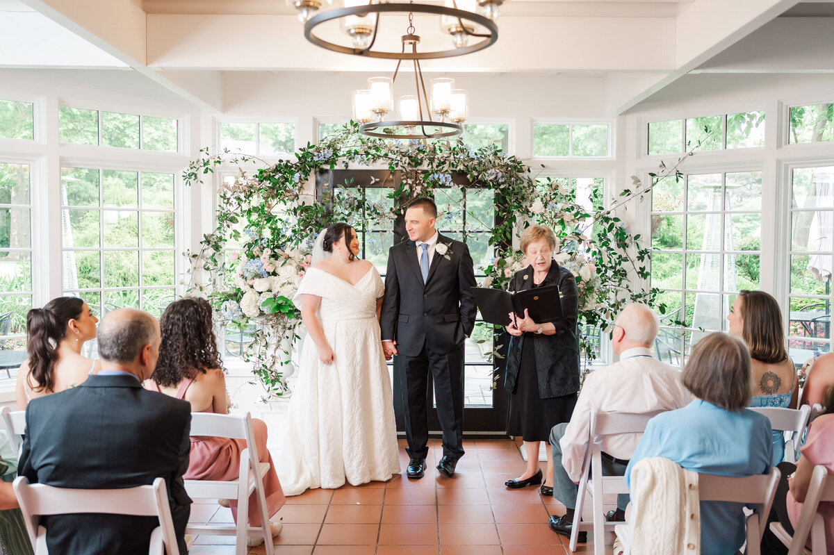 wedding ceremony taking place in the cafe at Frick Museum