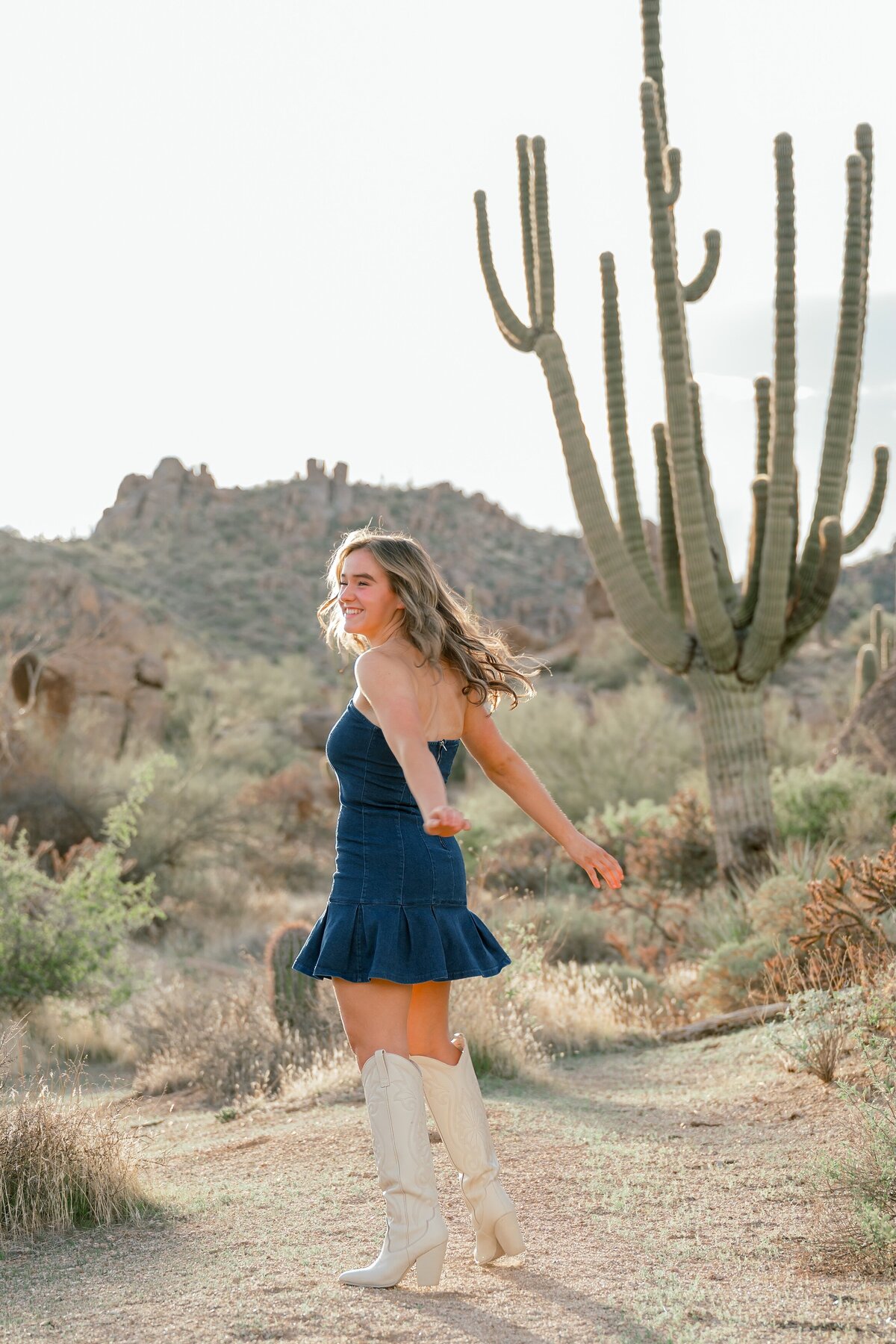 senior girl dancing in the desert 