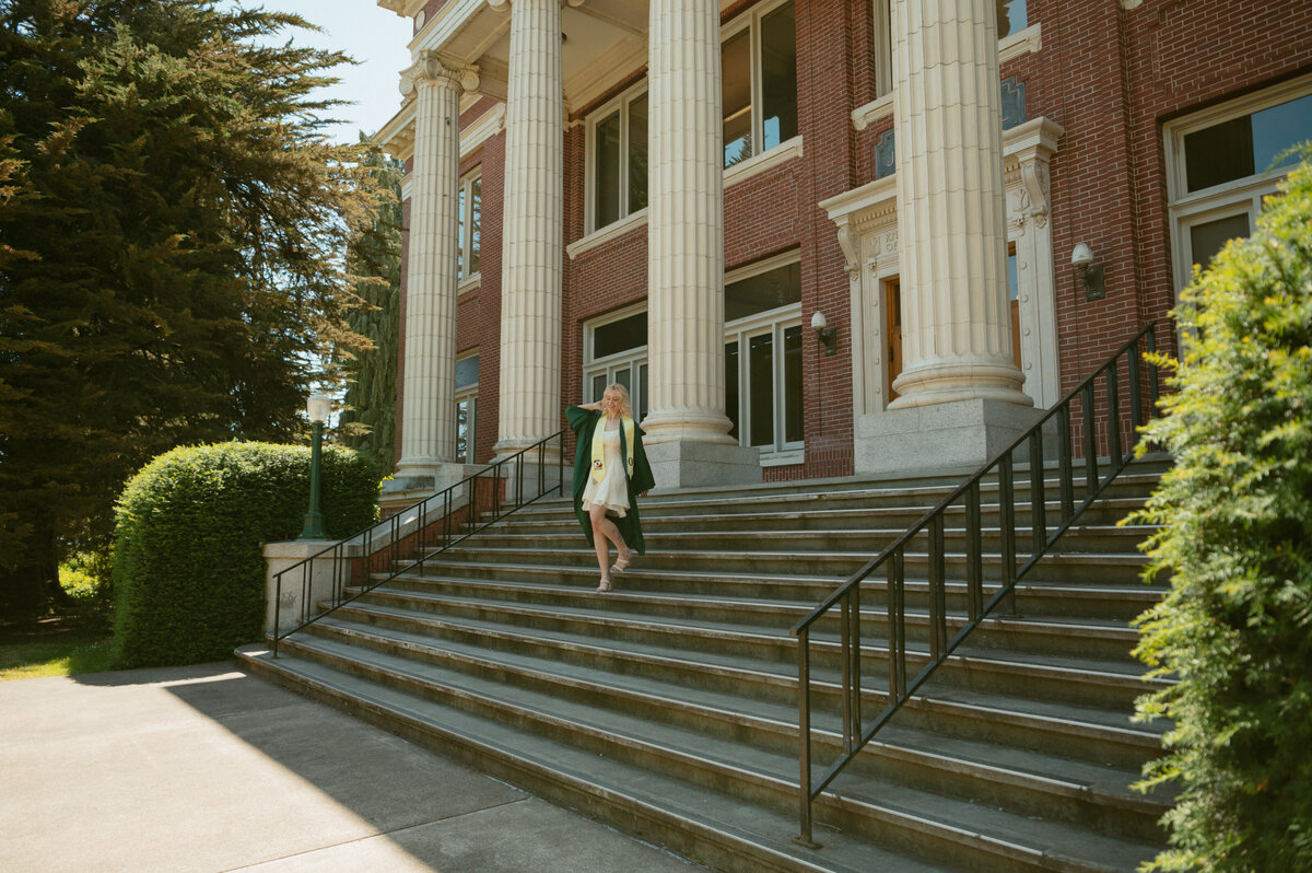 College senior wearing a flowing yellow dress, smiling confidently in natural outdoor light