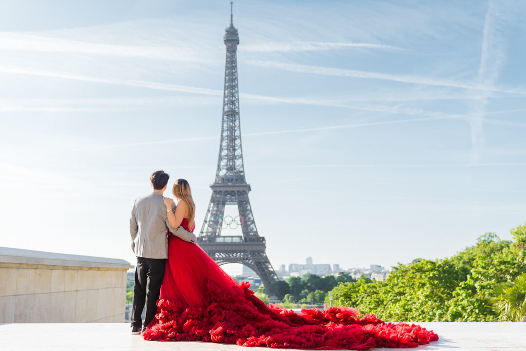 Romantic couple silhouette Paris, red princess dress, back view Eiffel Tower, intimate photography moment