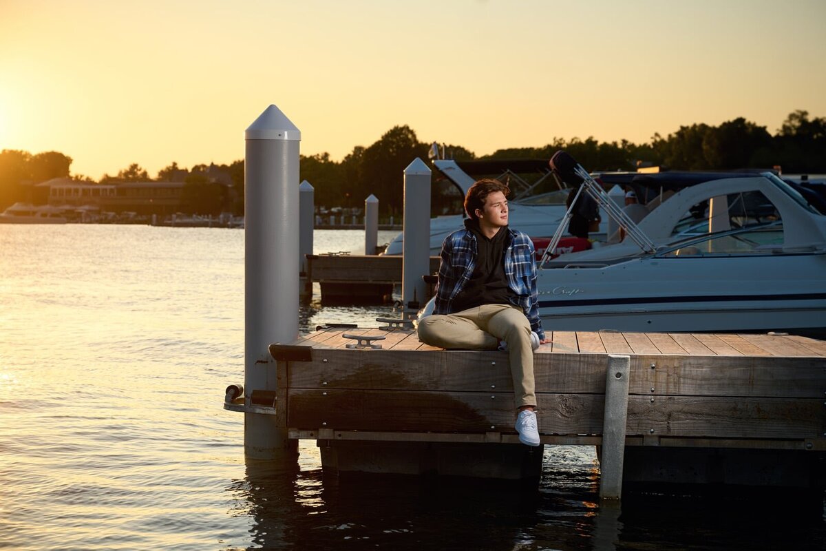 Senior Picture Photographer Captures Relaxed Portrait on Lakeside Dock at Sunset-101