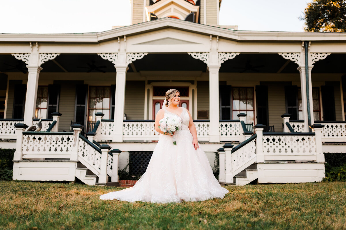 bride standing in front of a wedding venue in little rock for her outdoor wedding pictures