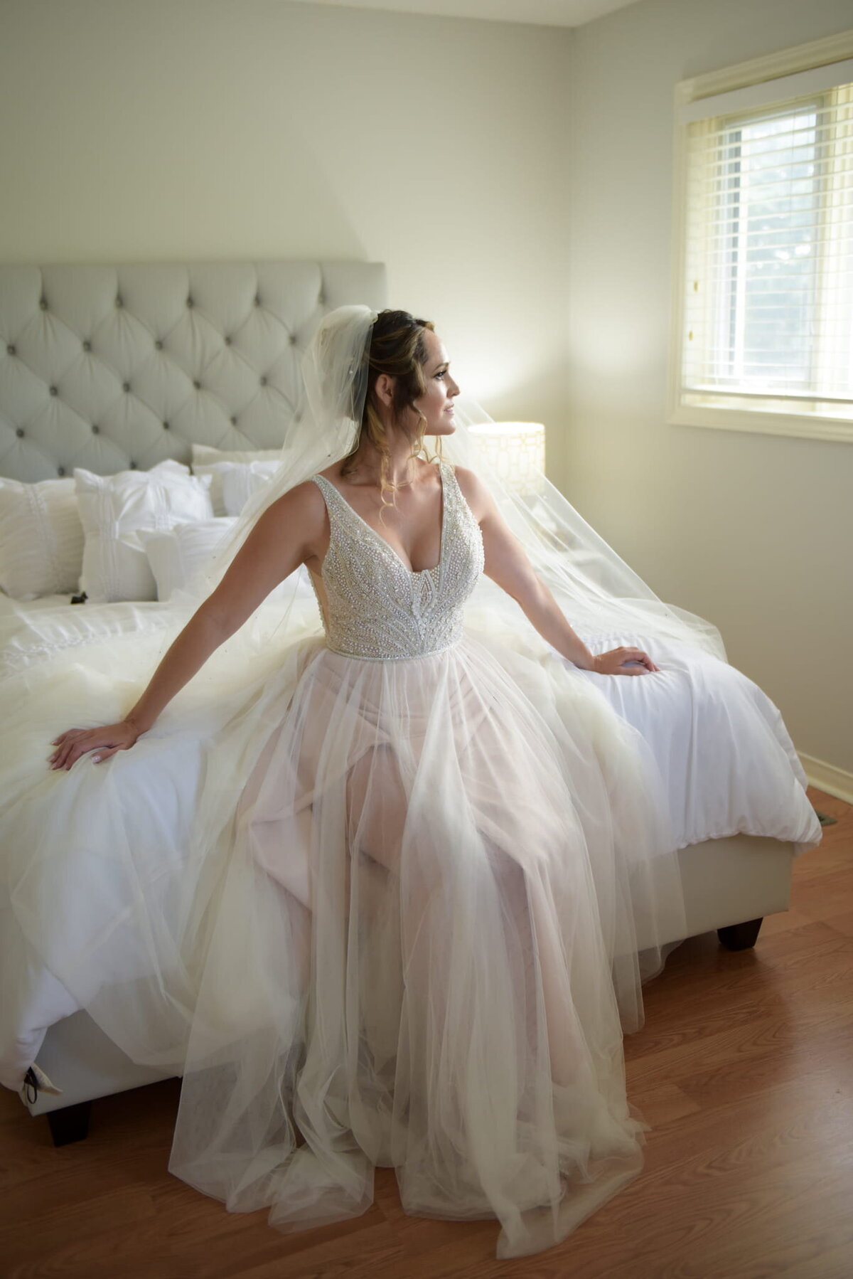 Bride seated with veil in a serene setting