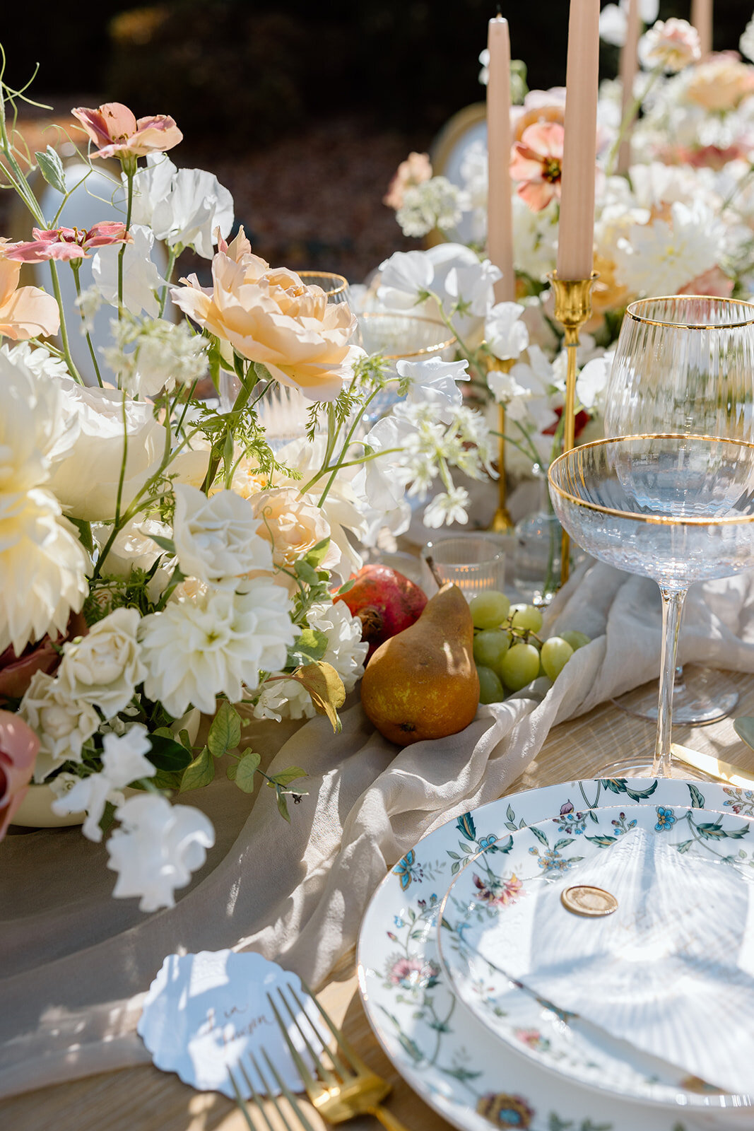 Elegant outdoor dinner tablescape with blush and cream florals in Tuxedo Park, NY.