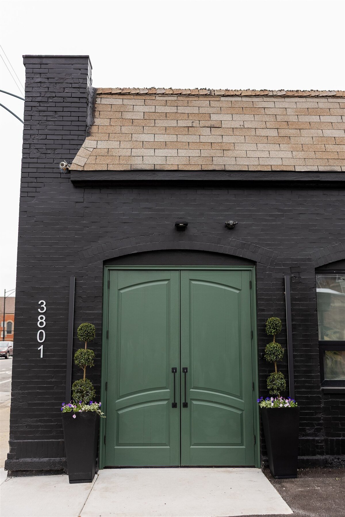 a one-of-a-kind double door entrance for guests, warm and welcoming green to show sneak peak of venue design