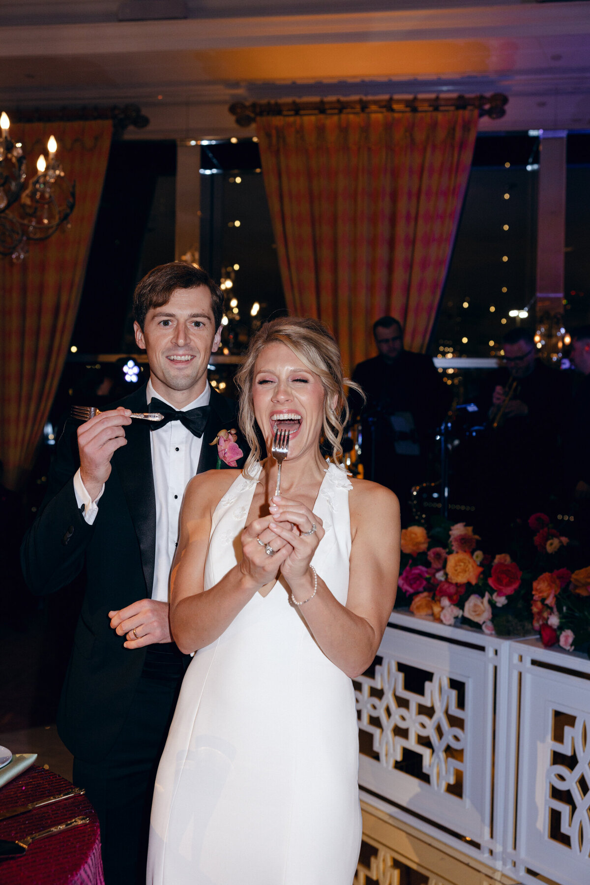 A wedding day photo of the bride and groom eating their wedding cake