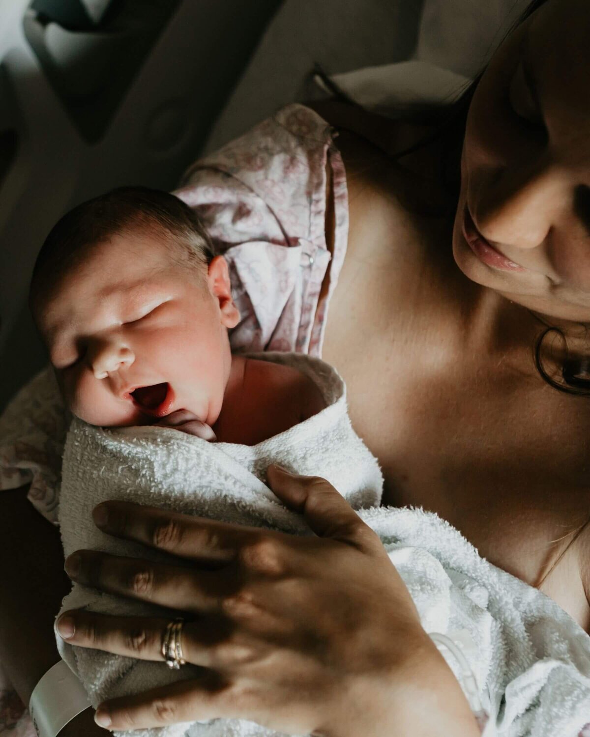 New mother holds her baby girl just after giving birth at Magee Women's Hospital in Pittsburgh