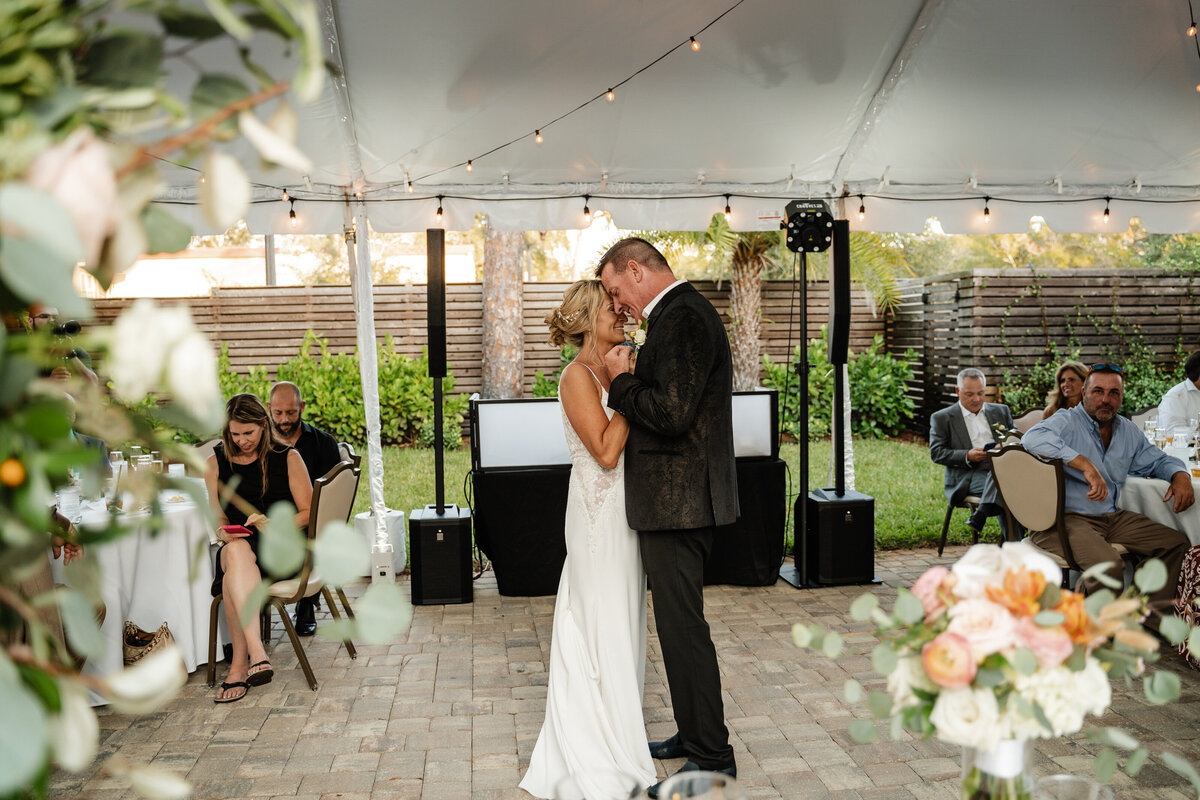 bride and groom share first dance in tent wedding in dunedin florida