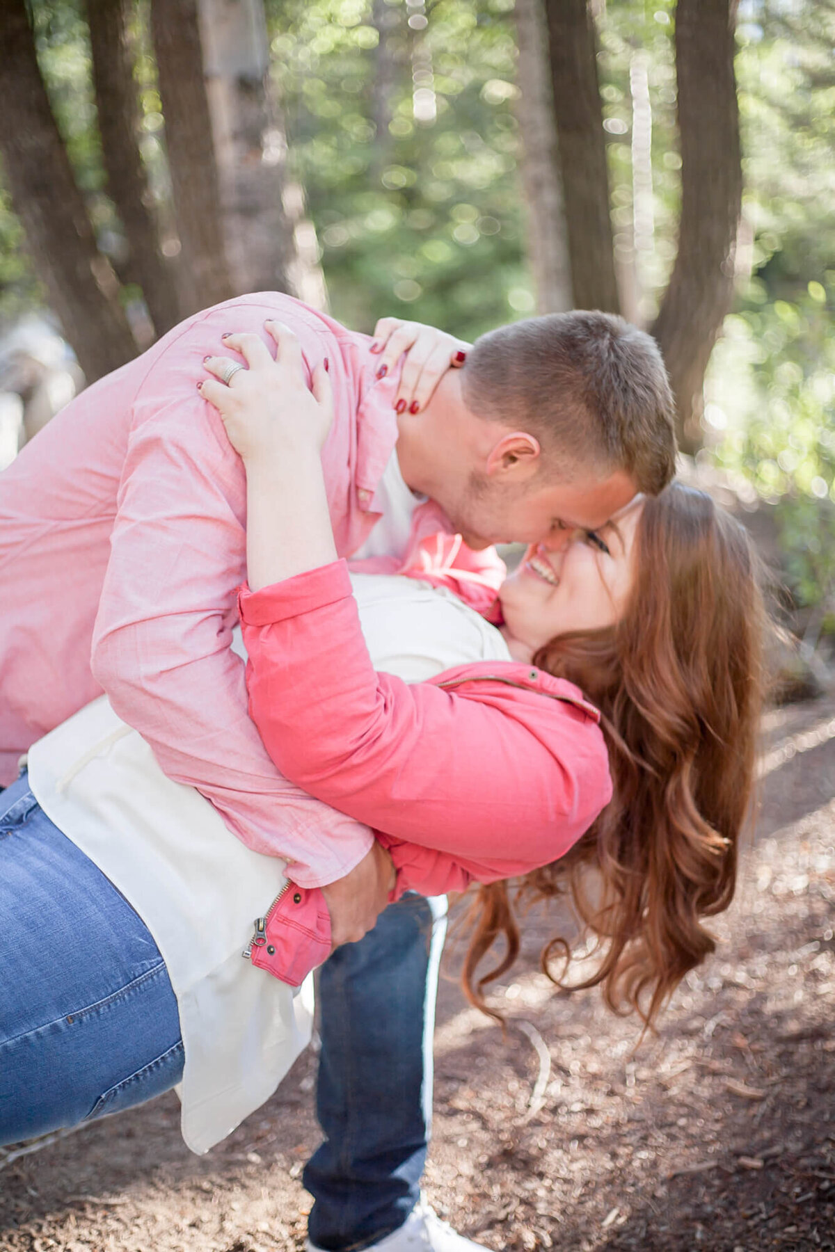 Engaged couple enjoying a dip and kiss in the mountains