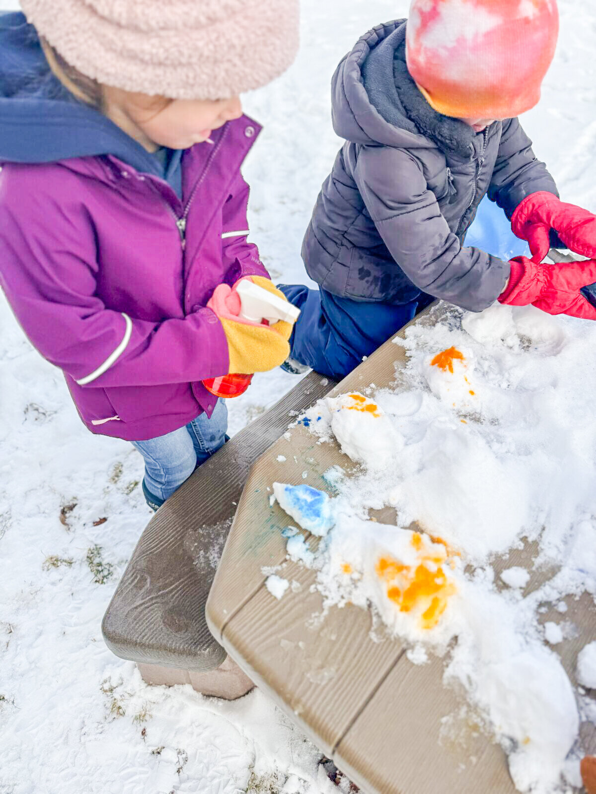 Students outside at House of Parker Preschool in Gorham Maine painting the snow in the winter gear they proudly put on  all by themselves!