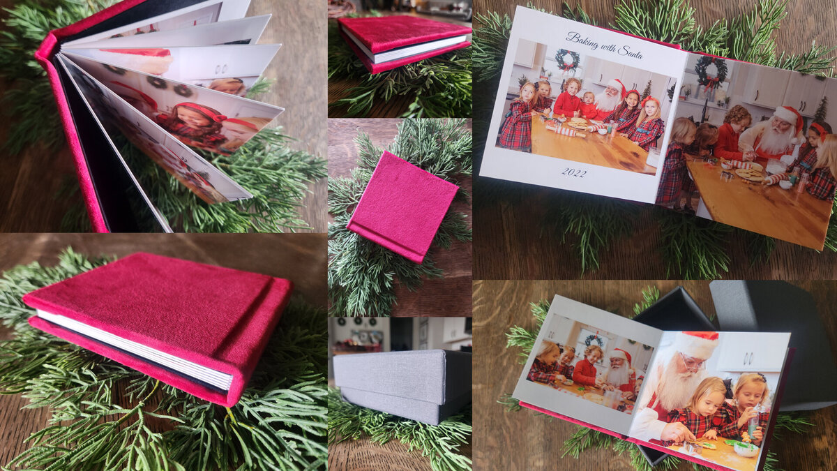 Atlanta Santa photographer red velvet album with Santa pictures inside laying on greenery