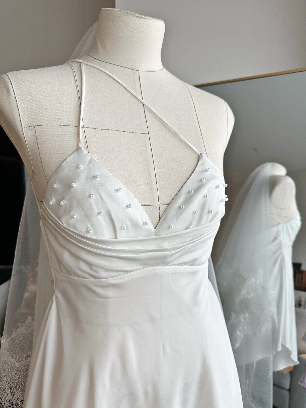 Bride wearing soft slip gown with luxurious sheen and fluid drape
